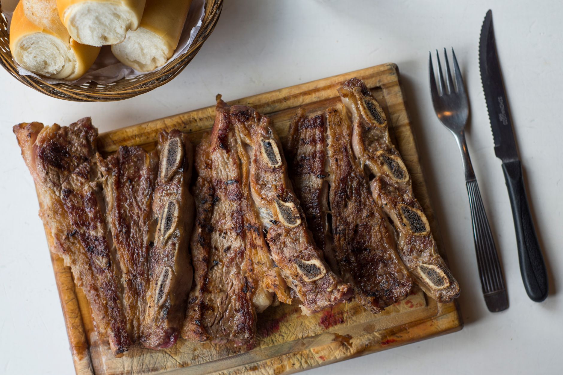 Grilled Argentinian steak on a parrilla with flames in the background