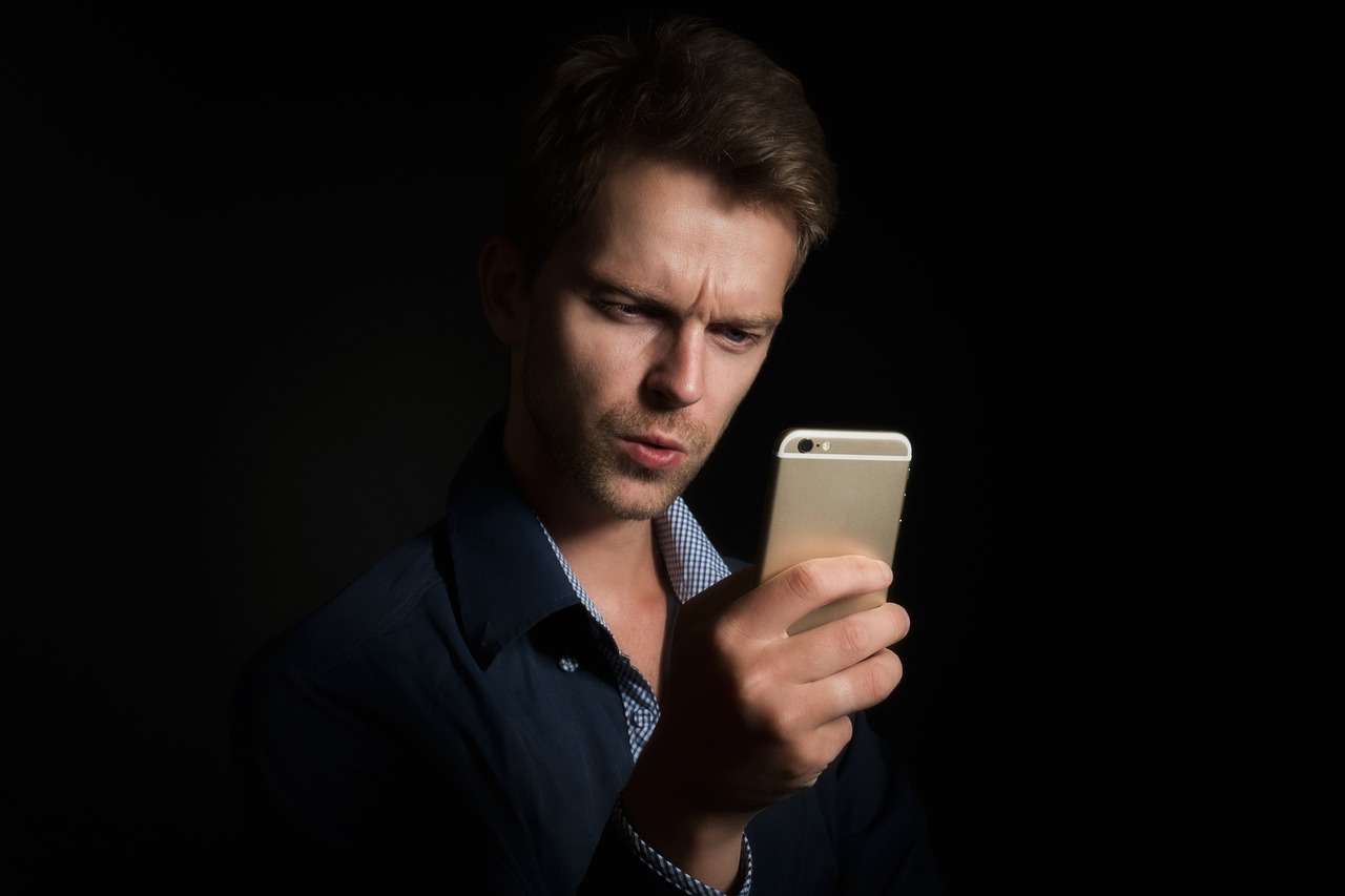 A person holding a smartphone with a translation app open, converting speech from one language to another.