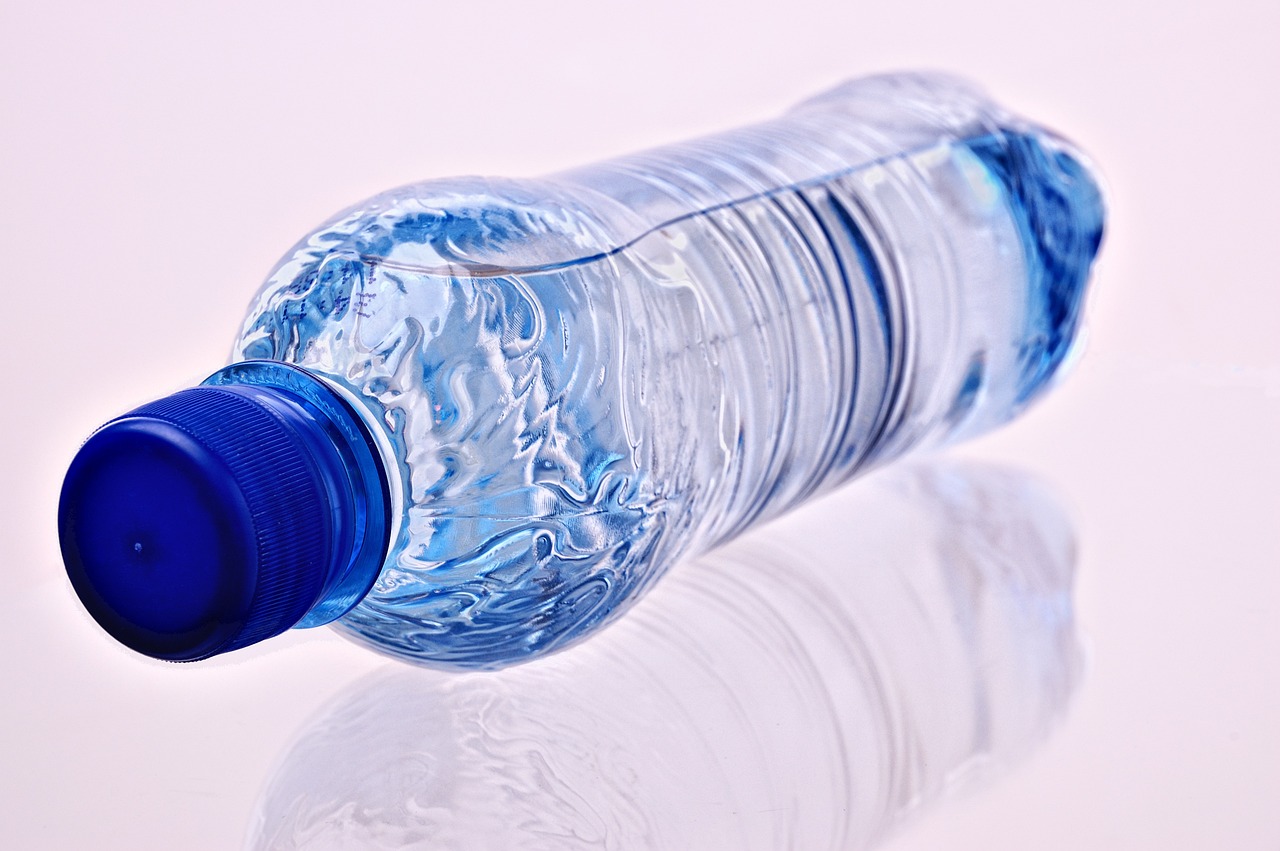 Grayl GeoPress water purifier bottle placed on a rock near a mountain stream