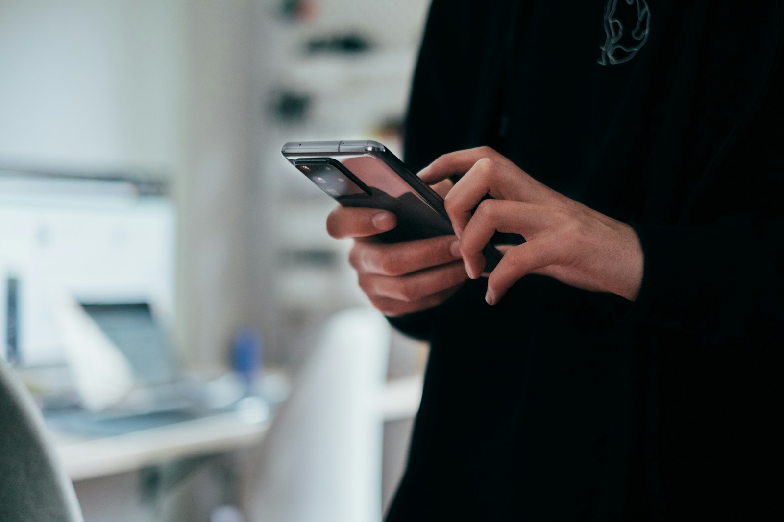 Person using a smartphone to check travel itinerary on a trip planning app