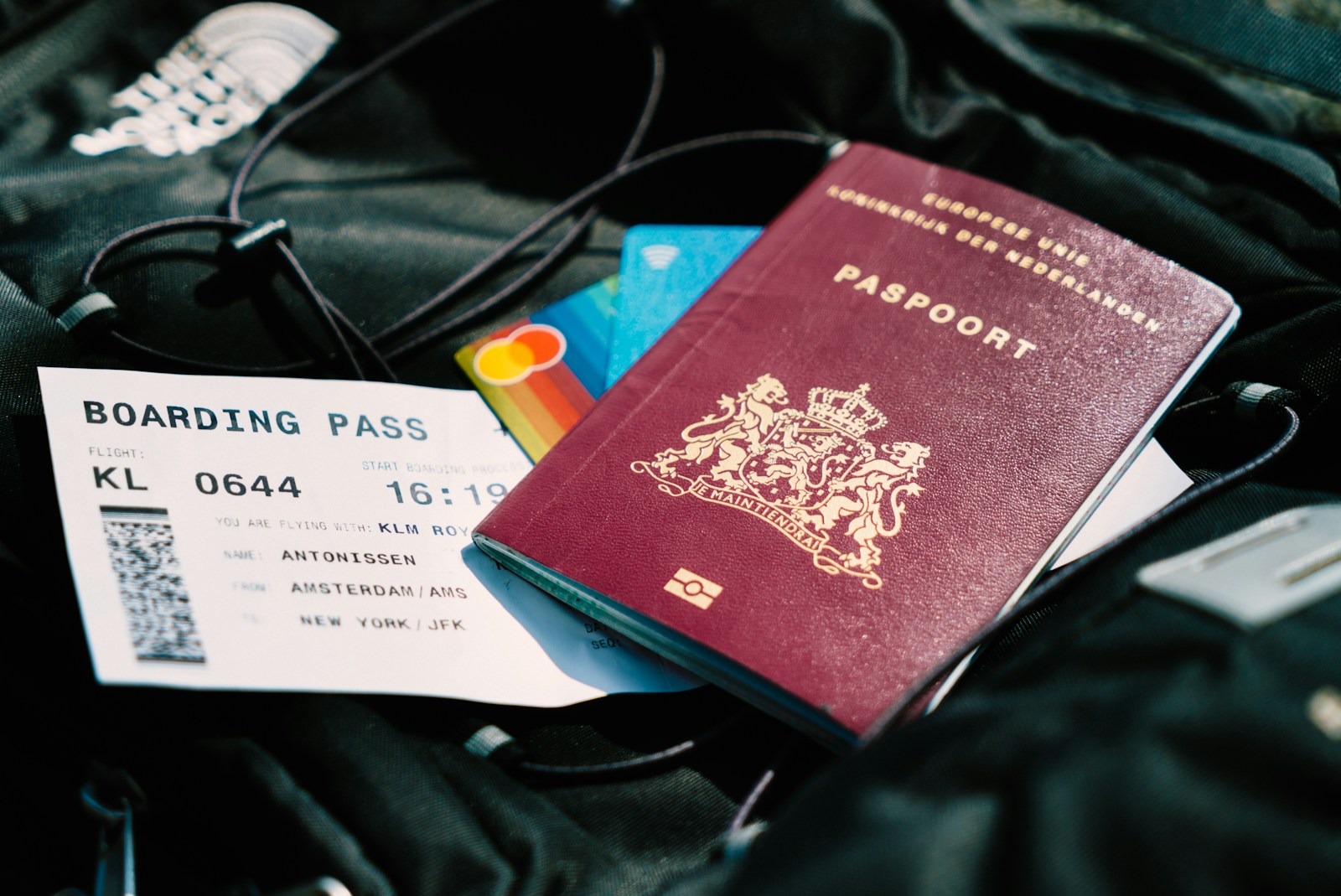 Travel insurance documents on a wooden table with a laptop and a coffee cup