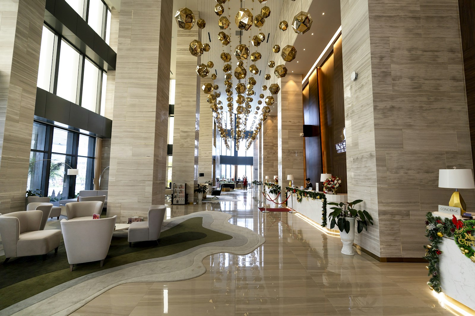 Modern luxury hotel lobby with elegant seating and chandelier
