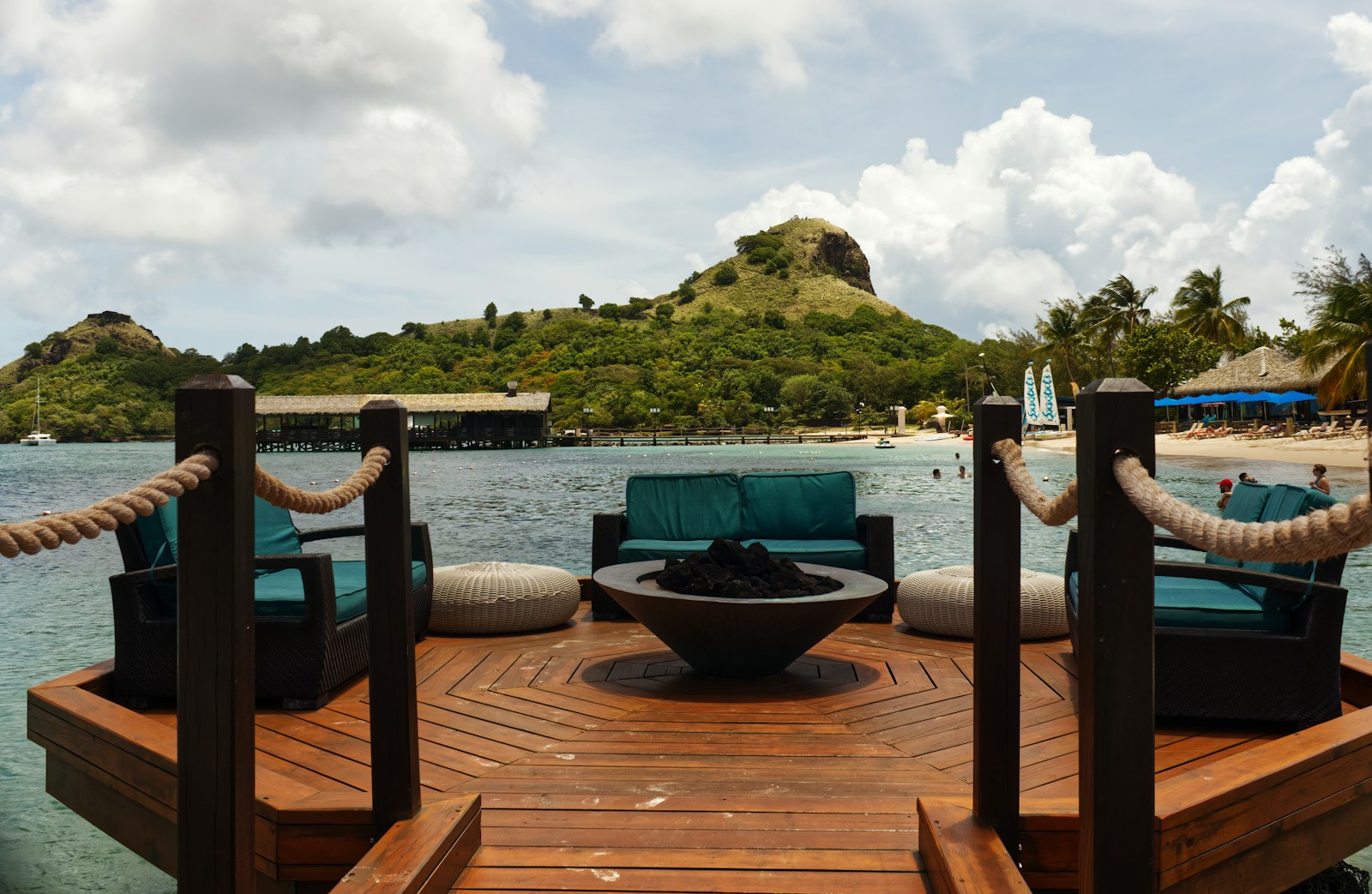 Overwater bungalows at Sandals Grande St. Lucian resort with beach and palm trees