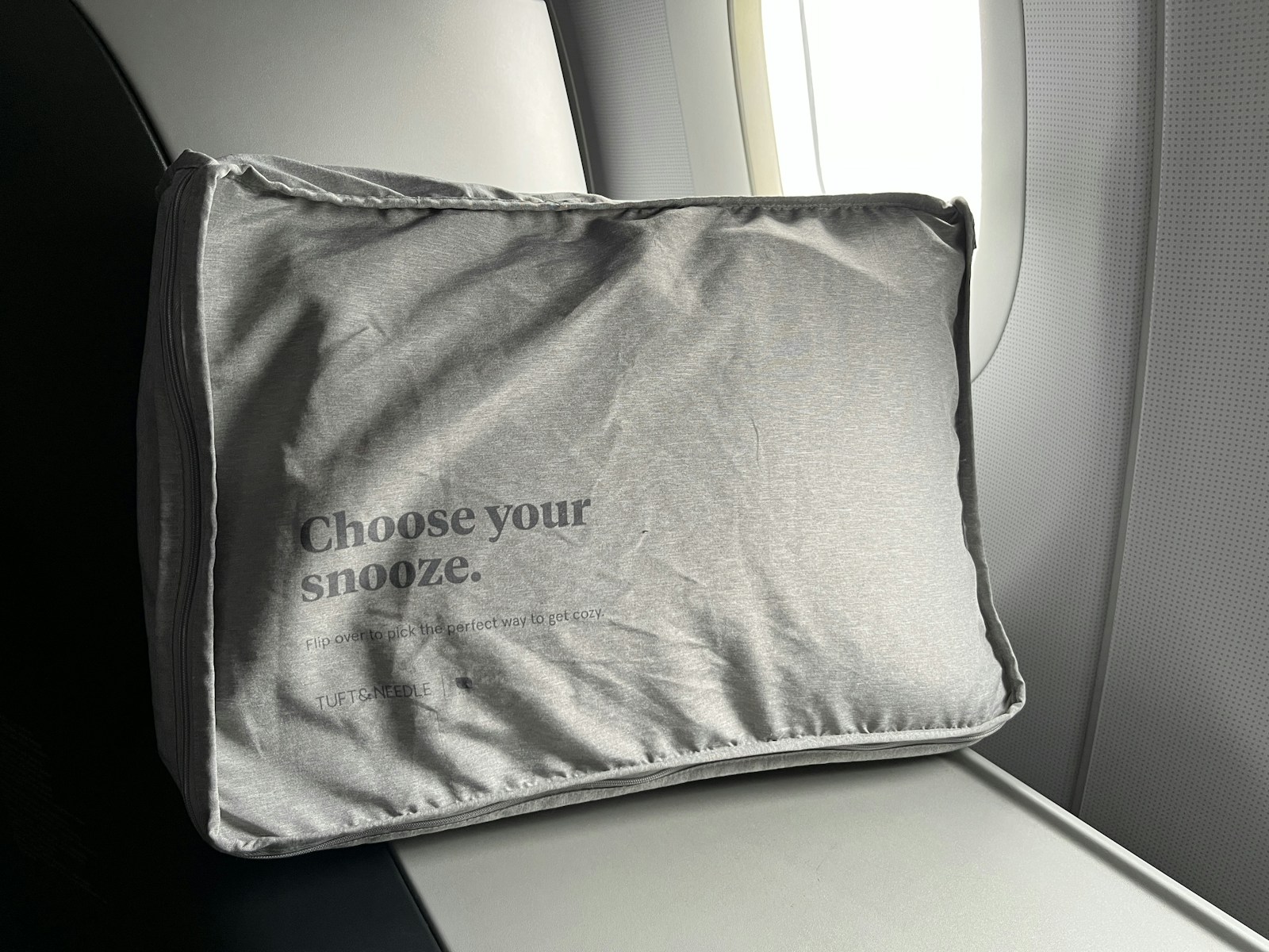 A selection of different travel pillows displayed side by side on a table for comparison