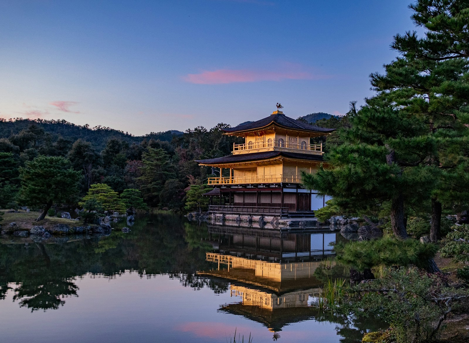 The Golden Pavilion at Kinkaku-ji reflected in the pond surrounded by autumn foliage in Kyoto