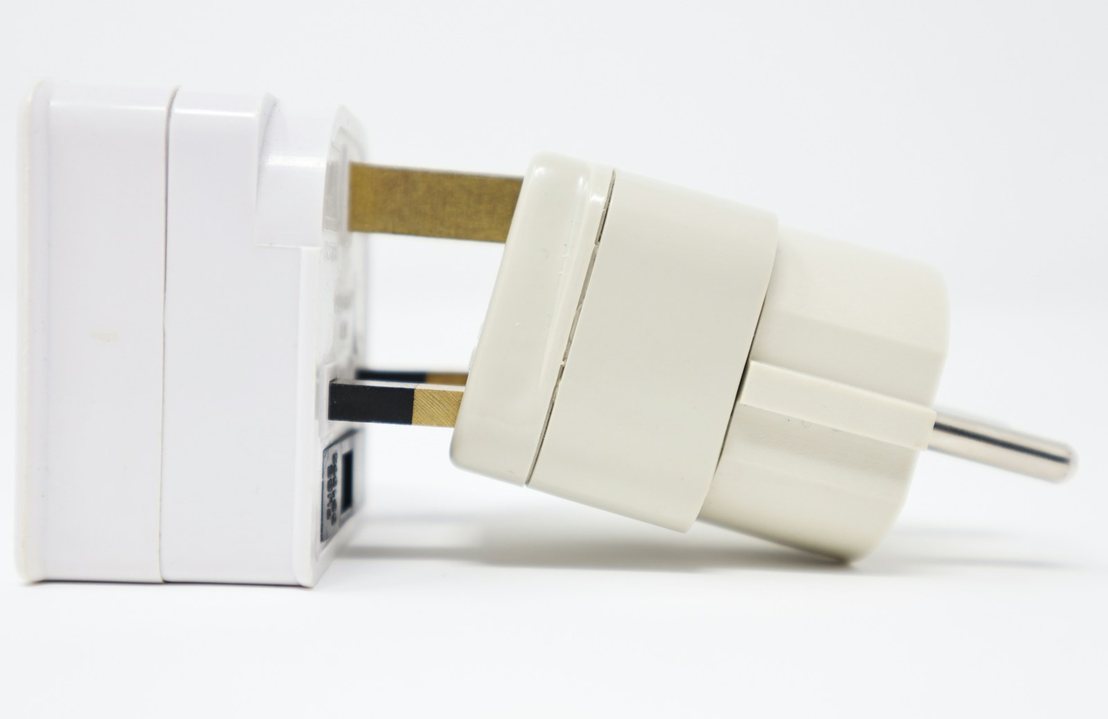 Close-up of a universal travel adapter with USB-C ports plugged into a wall outlet