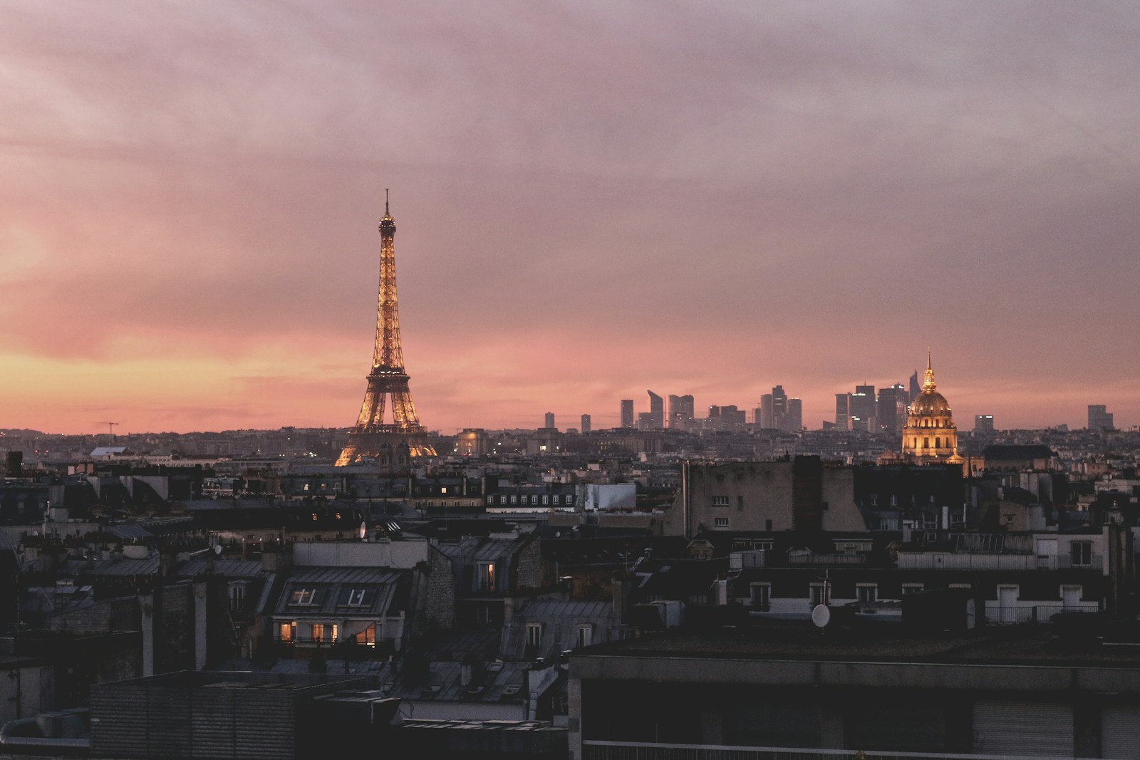 Rooftop bar in Paris with a view of the Eiffel Tower at golden hour