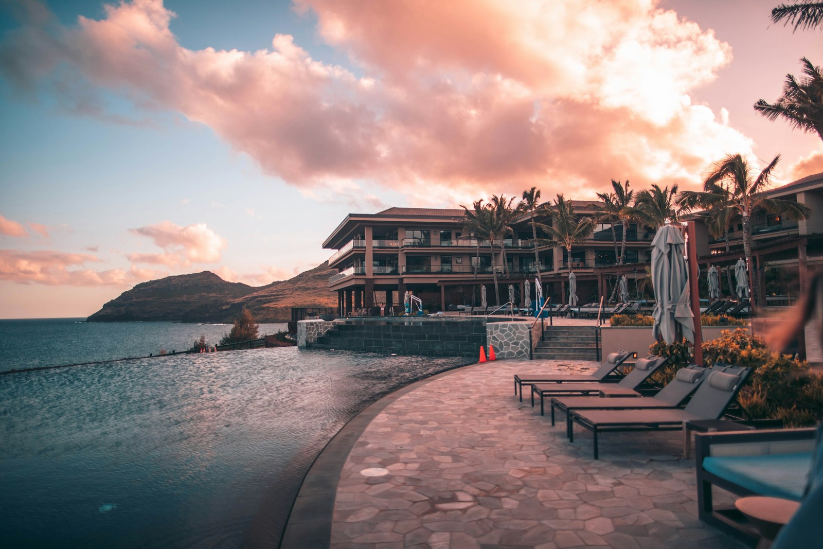 Travel essentials for a luxury spa getaway including sunscreen, water bottle, and linen clothing