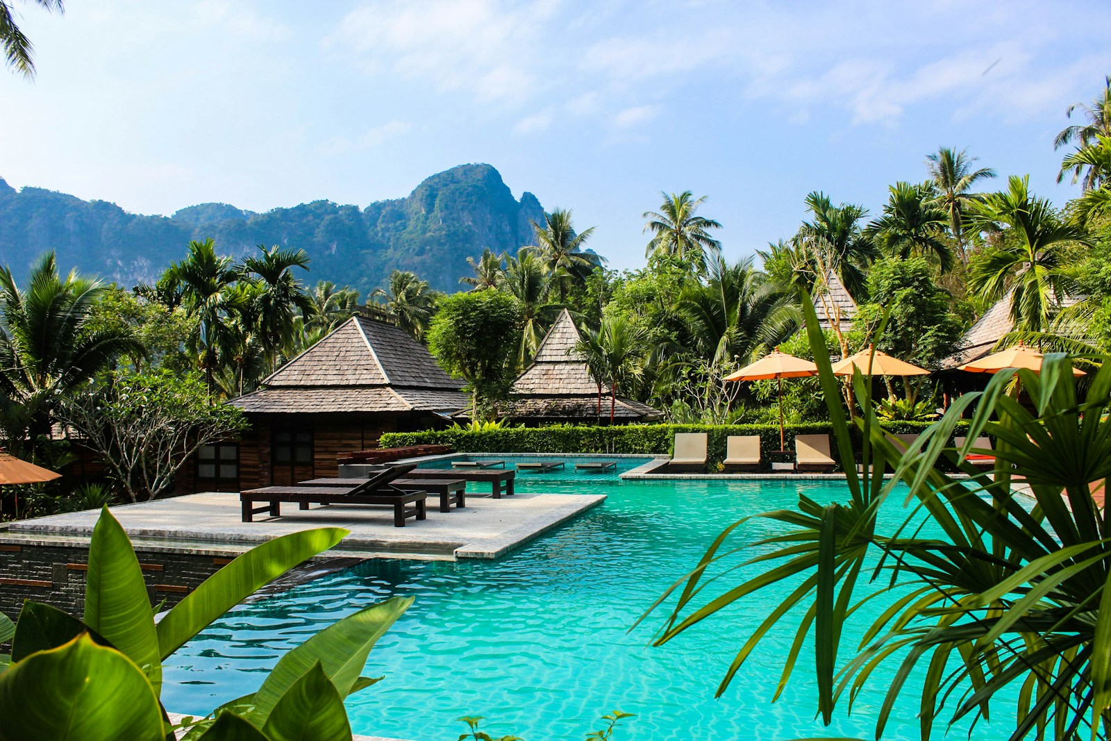 A luxury spa resort in Thailand with an infinity pool overlooking the ocean and limestone karsts