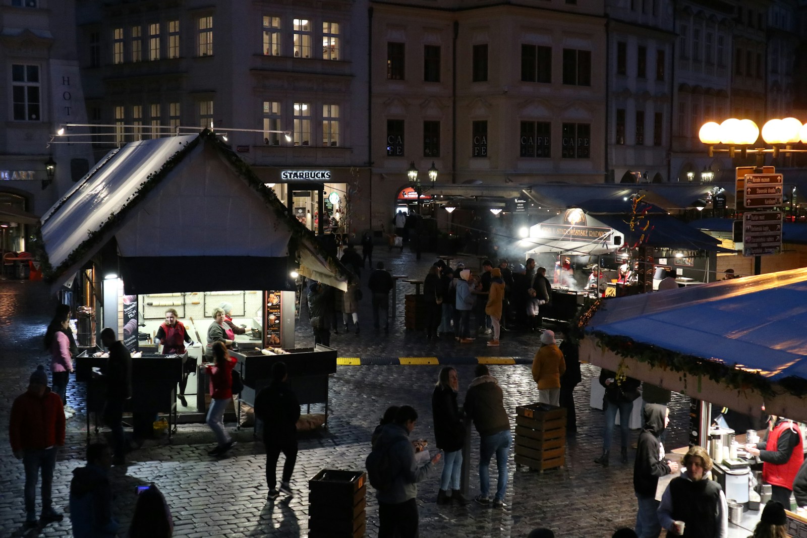 A lively local food market in Prague with colorful fresh produce stalls and a few shoppers