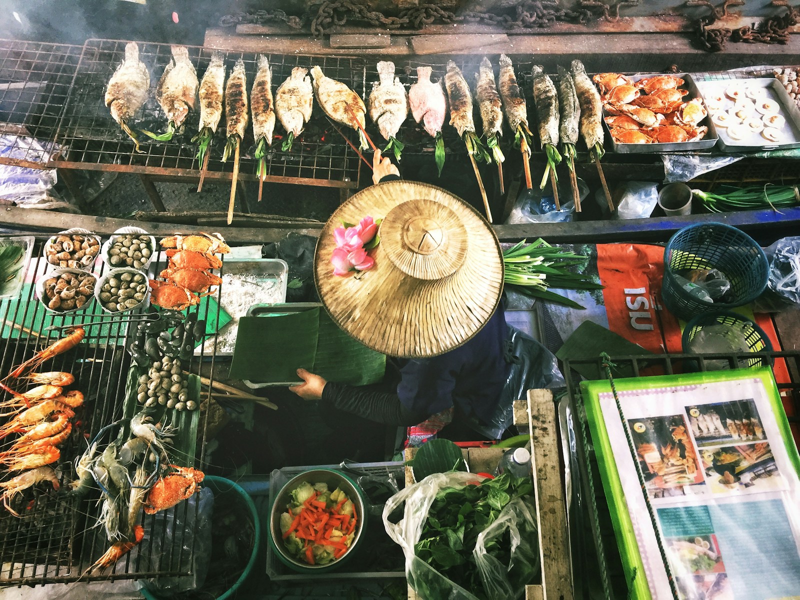 Street food vendor cooking pad thai in a wok at a night market in Thailand