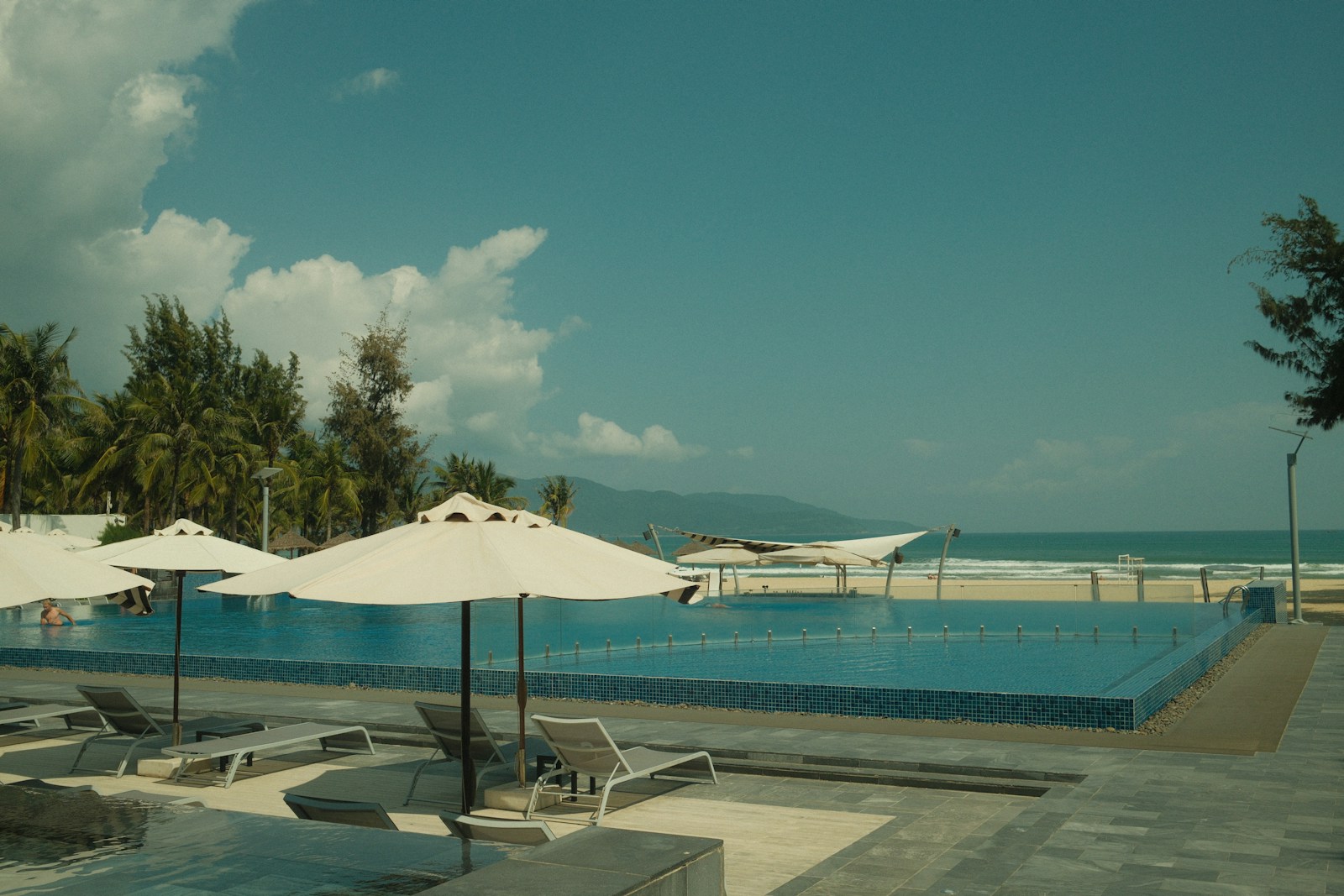Packing essentials for a luxury beach resort including sunscreen, hat, and sunglasses