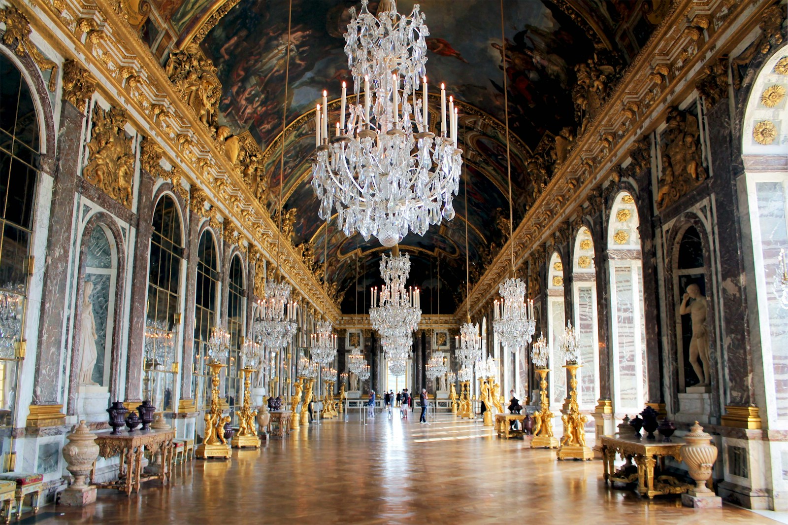 The Hall of Mirrors at the Palace of Versailles with crystal chandeliers