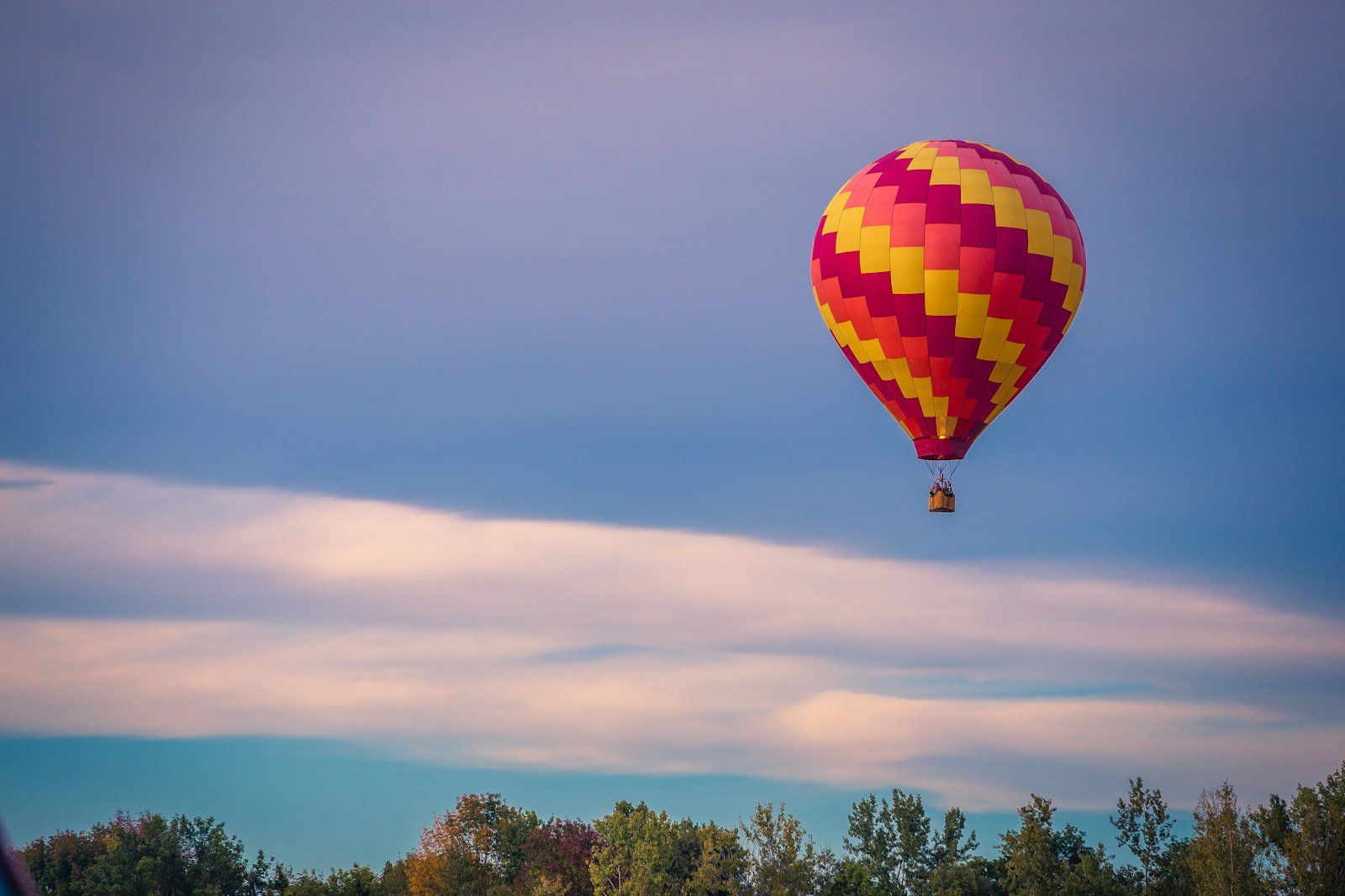 Hot air balloons floating over ancient temples at sunrise in Bagan, Myanmar offering a luxury travel experience