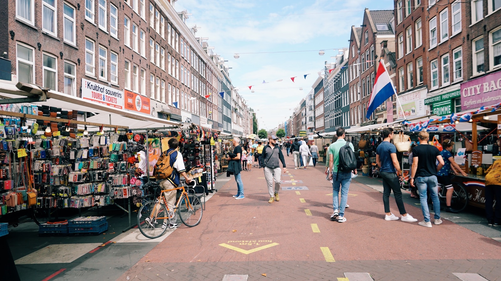 Colorful market stall at Albert Cuypmarkt in Amsterdam with fresh produce and Dutch snacks