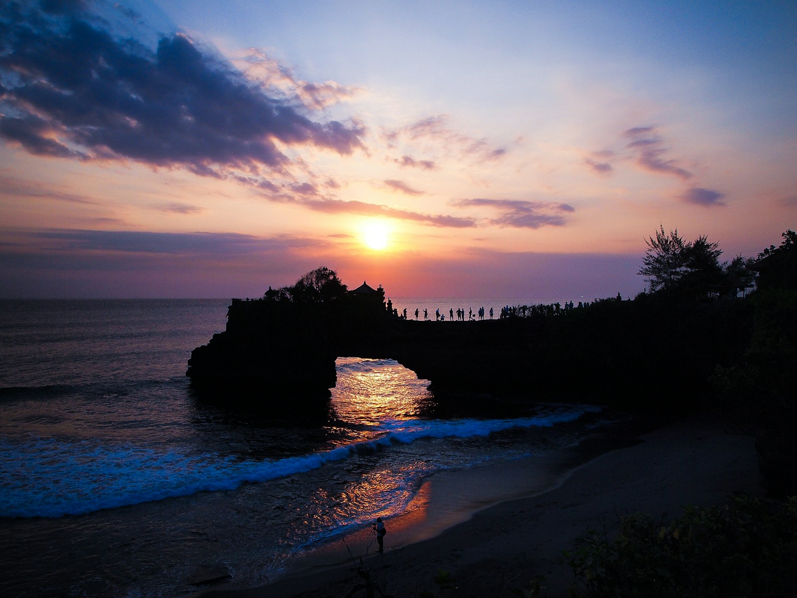Sunset at Tanah Lot temple on a rocky island off the coast of Bali