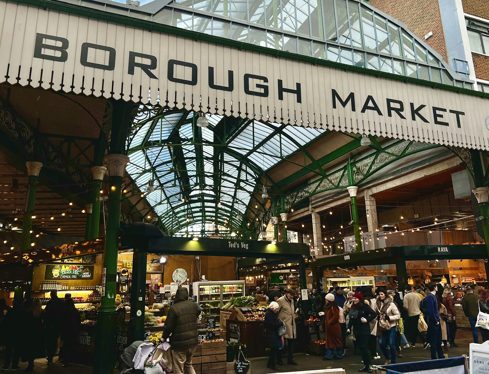 Busy food market in London with shoppers at various stalls